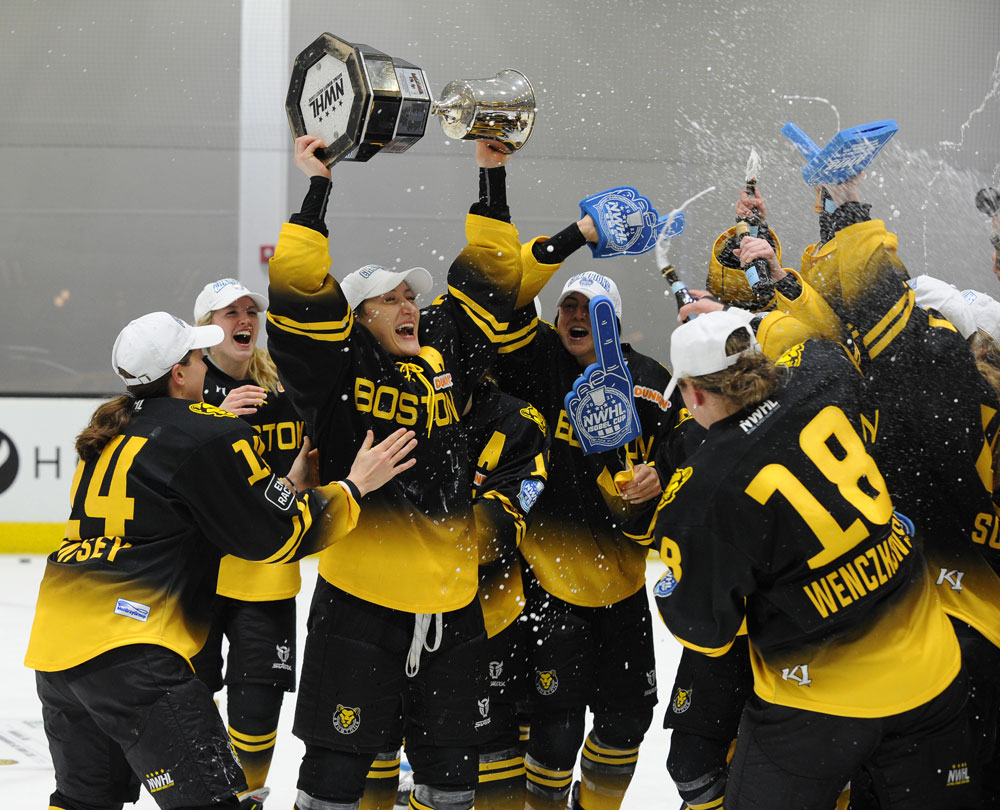 Alternate Captain Kaleigh Fratkin #13 of the Boston Pride proudly hoists the Isboel Cup amongst her teammates after winning the National Women’s Hockey League (NWHL) Isobel Cup final game on March 27, 2021 at the Warrior Ice Arena in Brighton, Massachusetts, USA. The Boston Pride beat the Minnesota Whitecaps 4 – 3 to win the Isobel Cup championship. (Photo credit – Steve Babineau/Hockey Hall of Fame).
